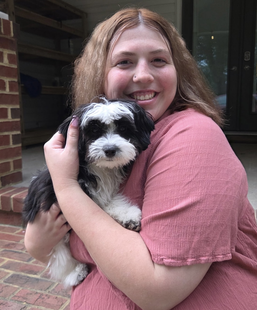 Rebecca Hirschman holding a dog at Ballypines Dog Ranch